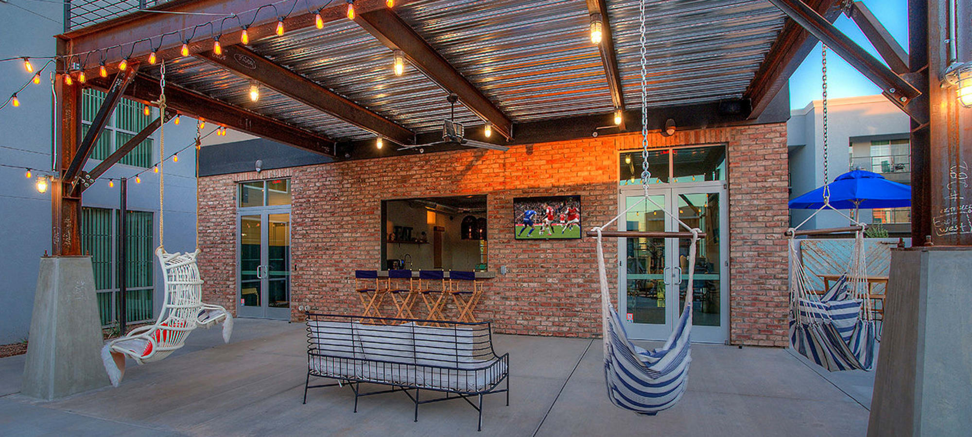 Hammocks and comfortable seating near the barbecue area at District Lofts in Gilbert, Arizona