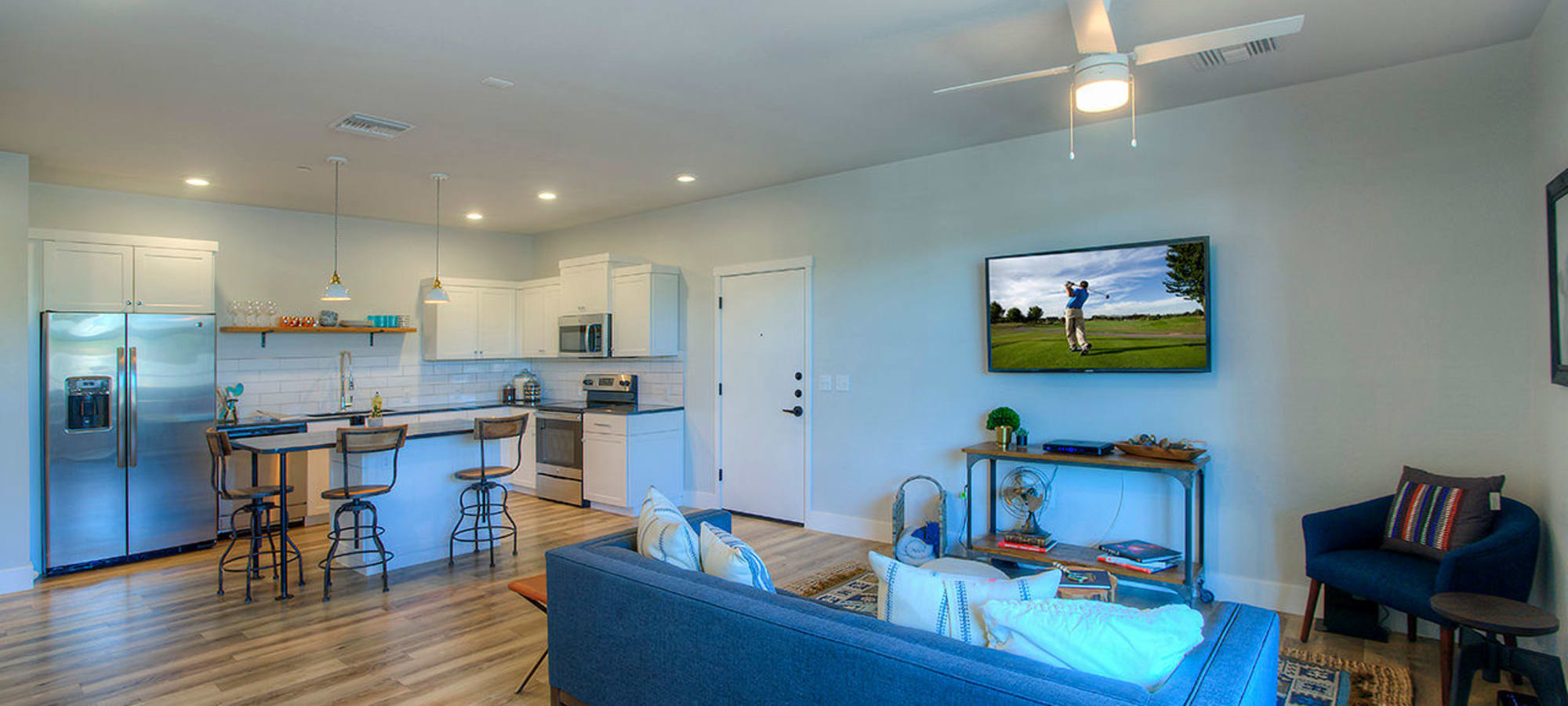 Ceiling fan and contemporary decor in open-concept living area of model home at District Lofts in Gilbert, Arizona