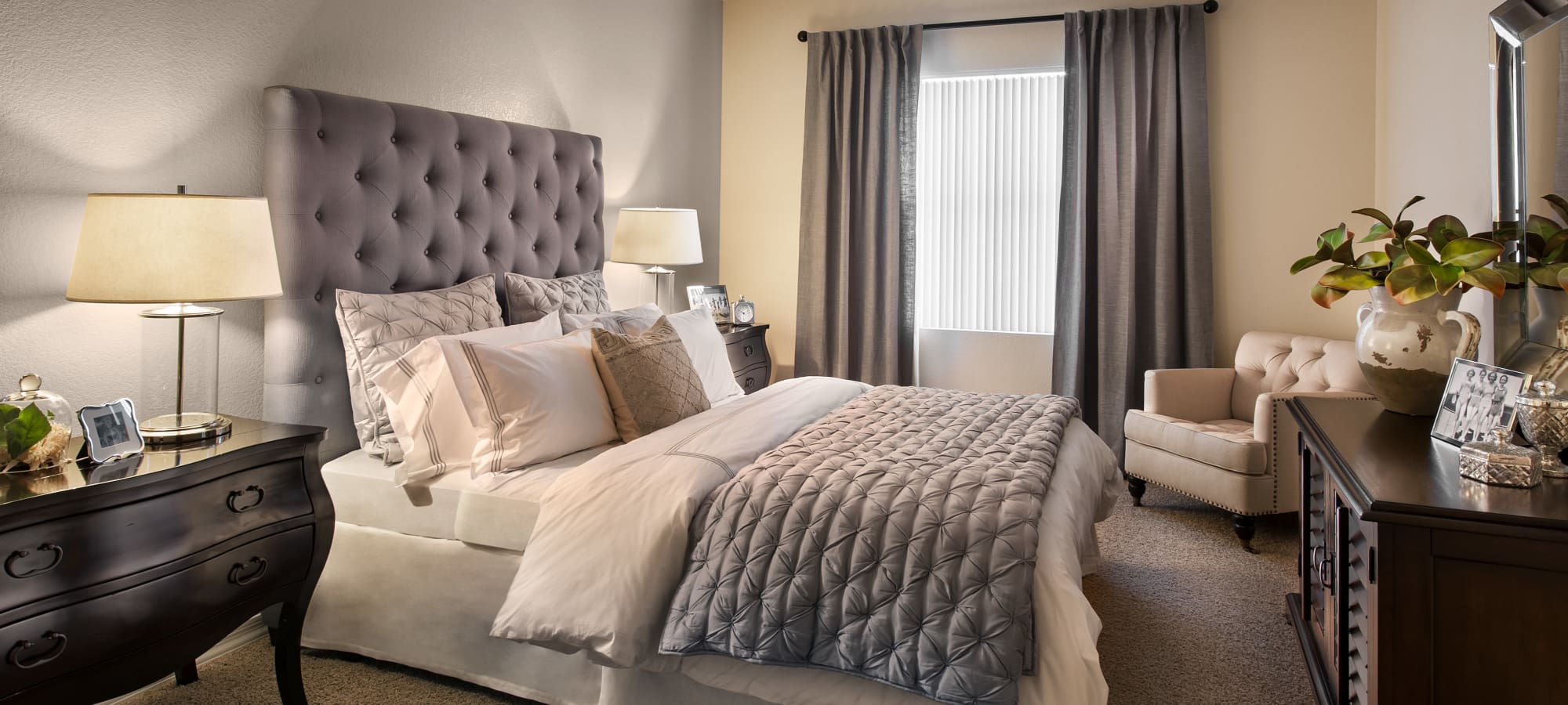 Draped windows and luxurious furnishings in master bedroom of model home at San Paseo in Phoenix, Arizona