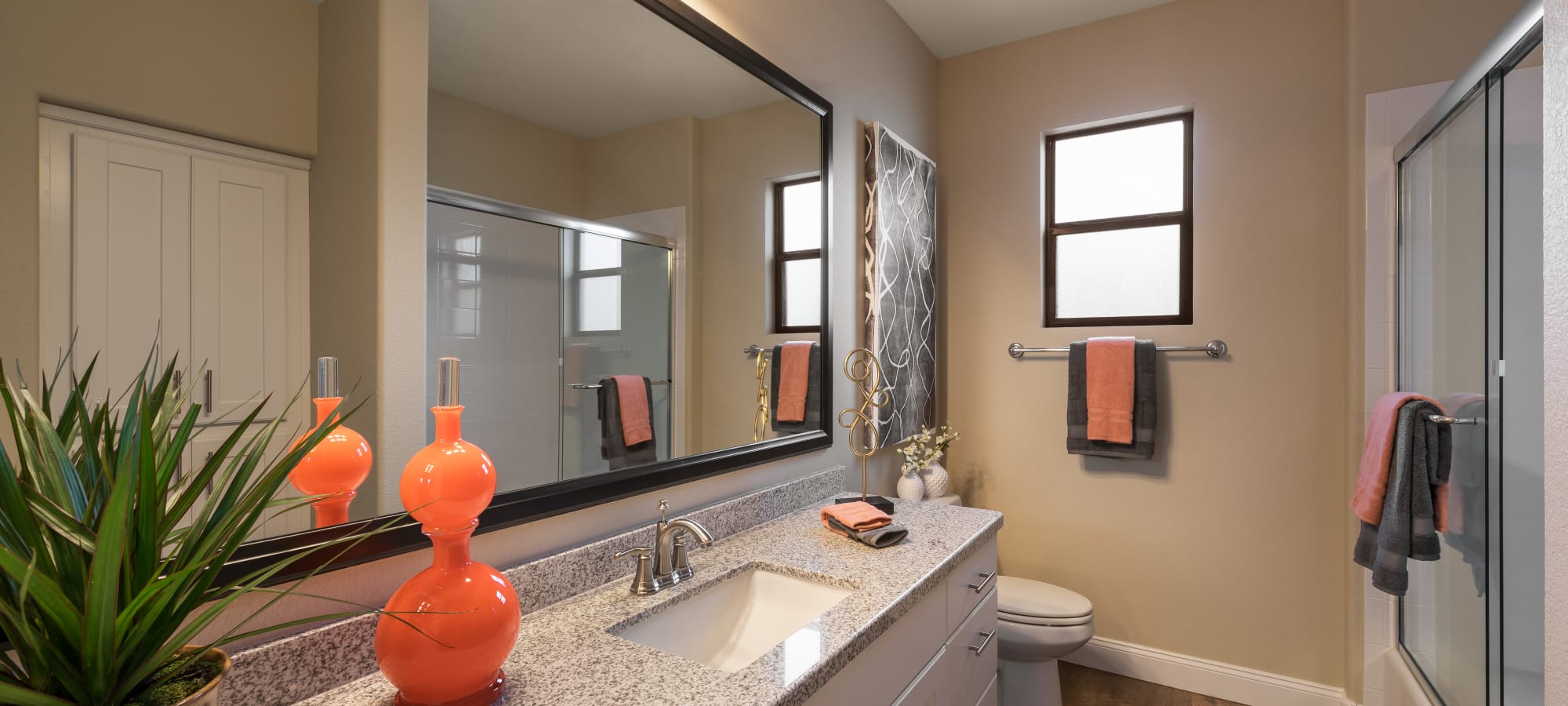 Large vanity mirror and granite countertop in bathroom of model home at San Piedra in Mesa, Arizona