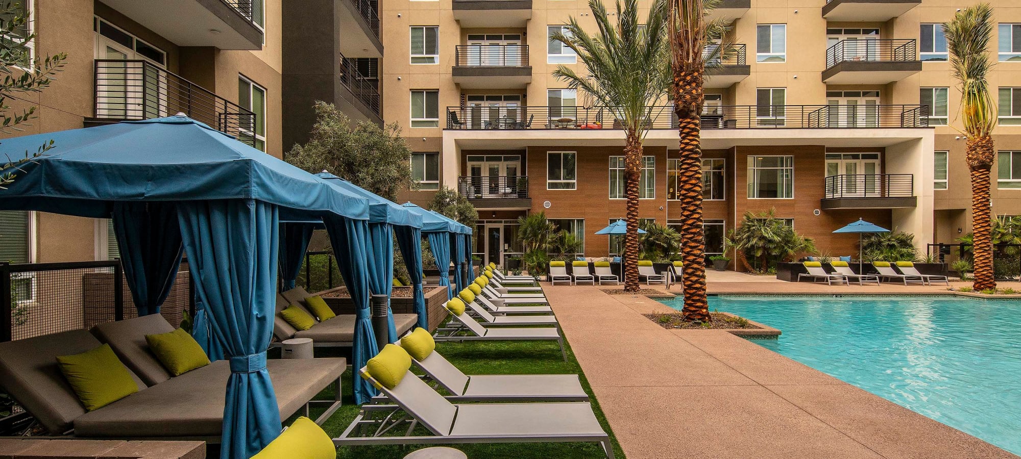Resort-style pool area with ample chaise lounge chairs and sun deck at Carter in Scottsdale, Arizona