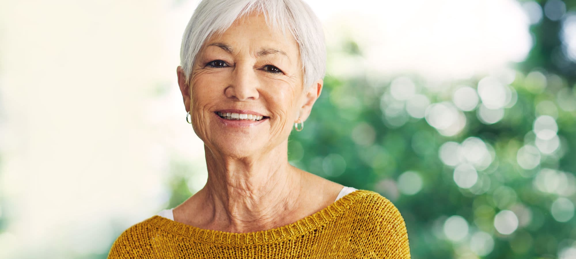 Elderly woman smiling wearing yellow short