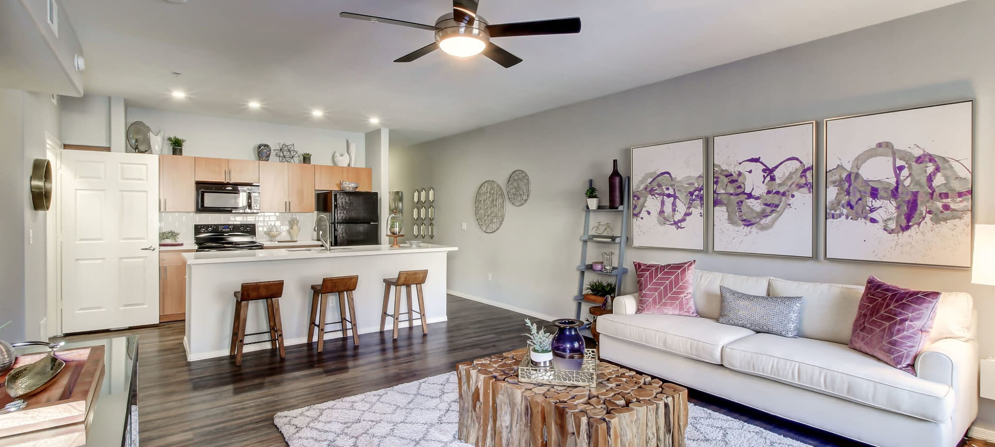 An apartment living room and kitchen at Spectra on 7th in Phoenix, Arizona