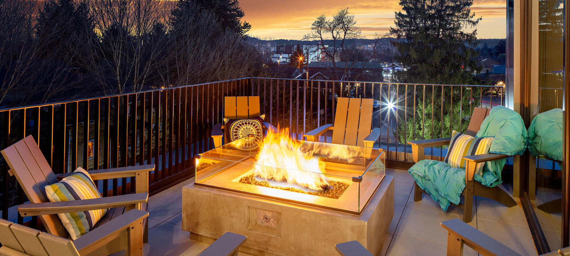Patio seating with a lit fire pit at Sandy Fifty One in Portland, Oregon