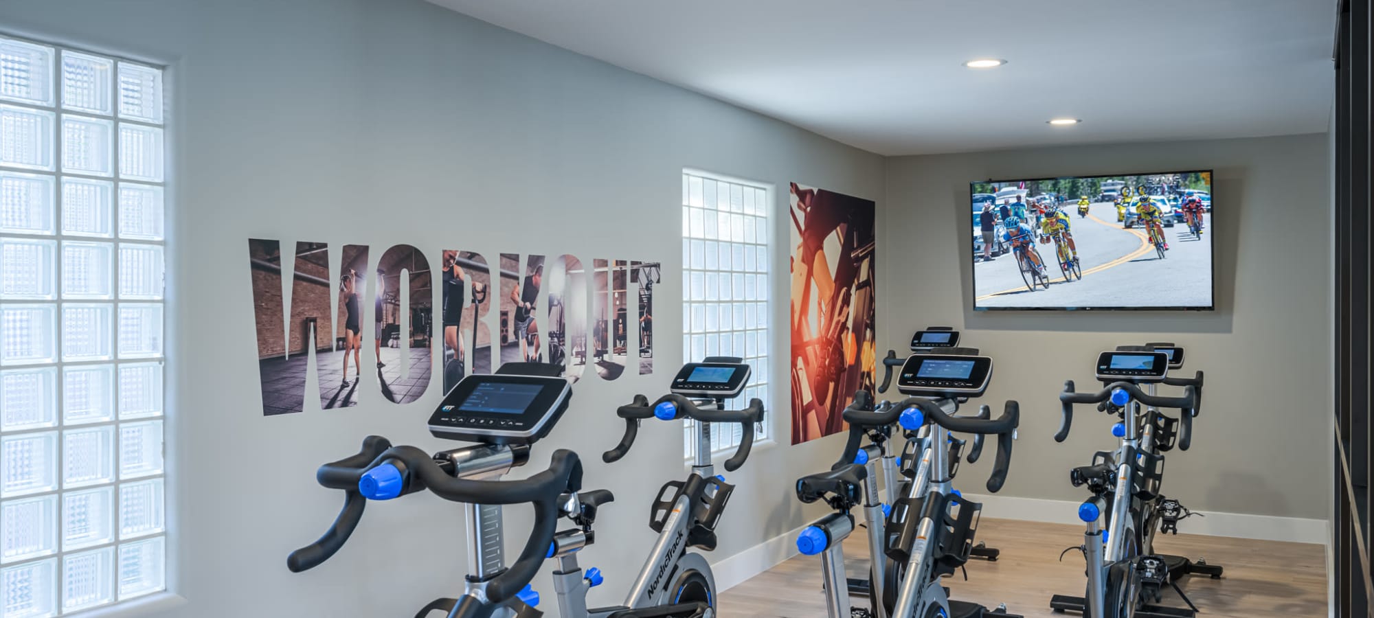Cardio room with stationary bikes and a tv mounted to the wall at Elite North Scottsdale in Scottsdale, Arizona