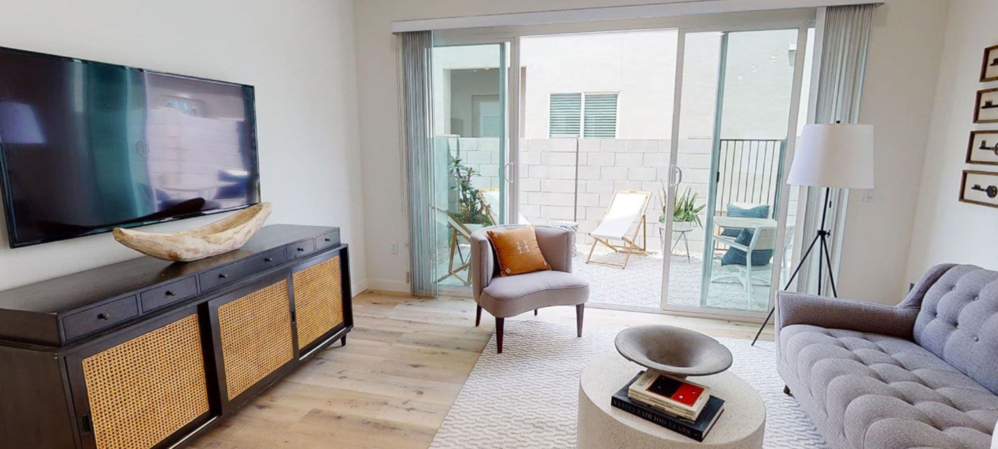 Modern living room featuring a patio area at Novella at Biltmore in Phoenix, Arizona