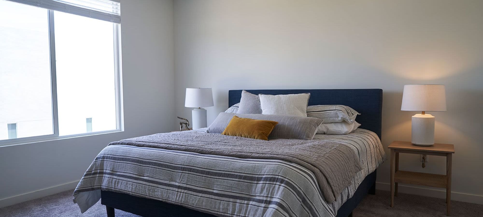 Model bedroom with ample amounts of natural light at Novella at Biltmore in Phoenix, Arizona