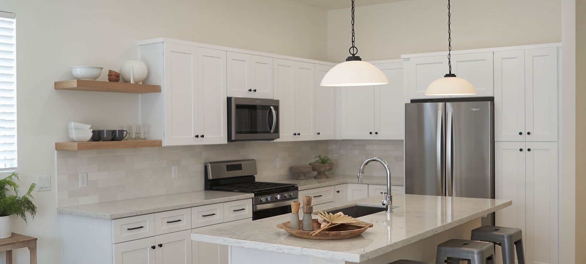 Kitchen area featuring modern and sleek appliances at Novella at Biltmore in Phoenix, Arizona