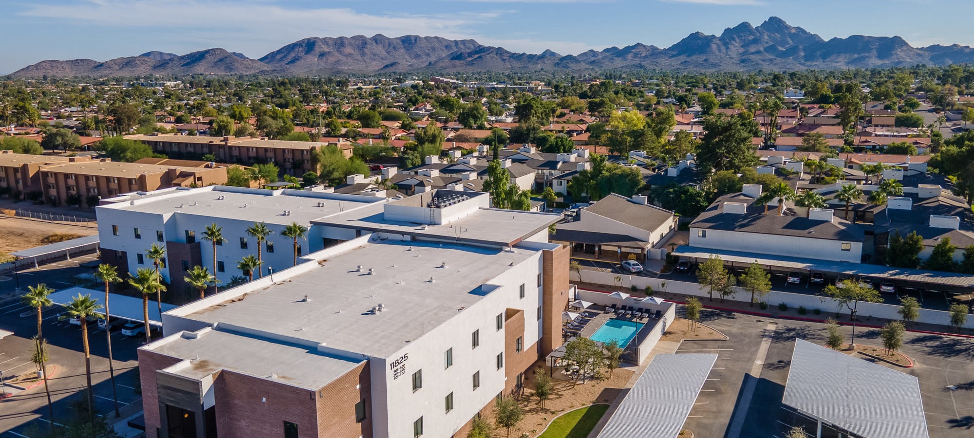View of the building and the covered parking spots at The Charleston Apartments in Phoenix, Arizona