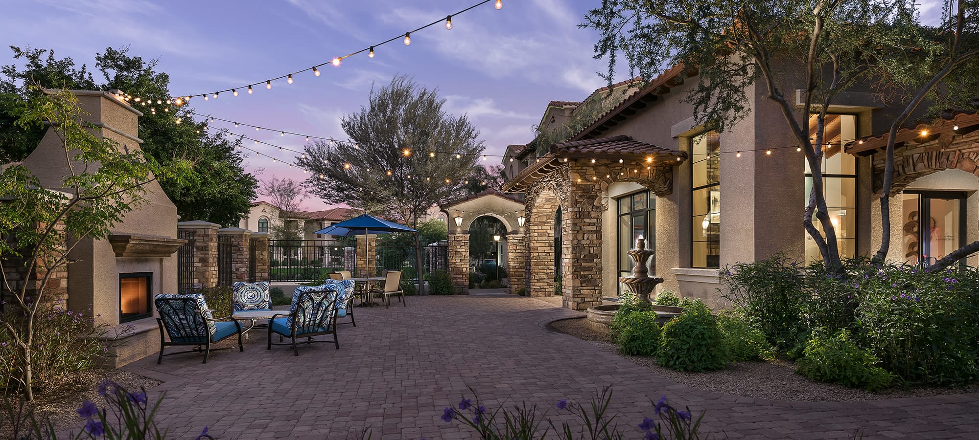 Community patio with outdoor fireplace at San Norterra in Phoenix, Arizona