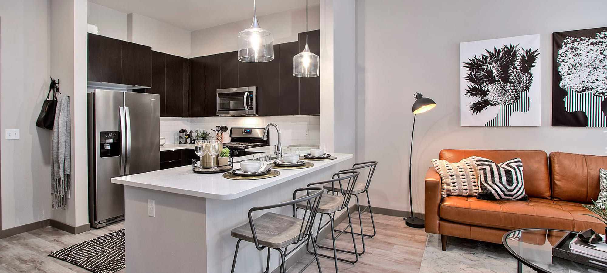 Model apartment's kitchen with an island and bar seating at Jade Apartments in Las Vegas, Nevada