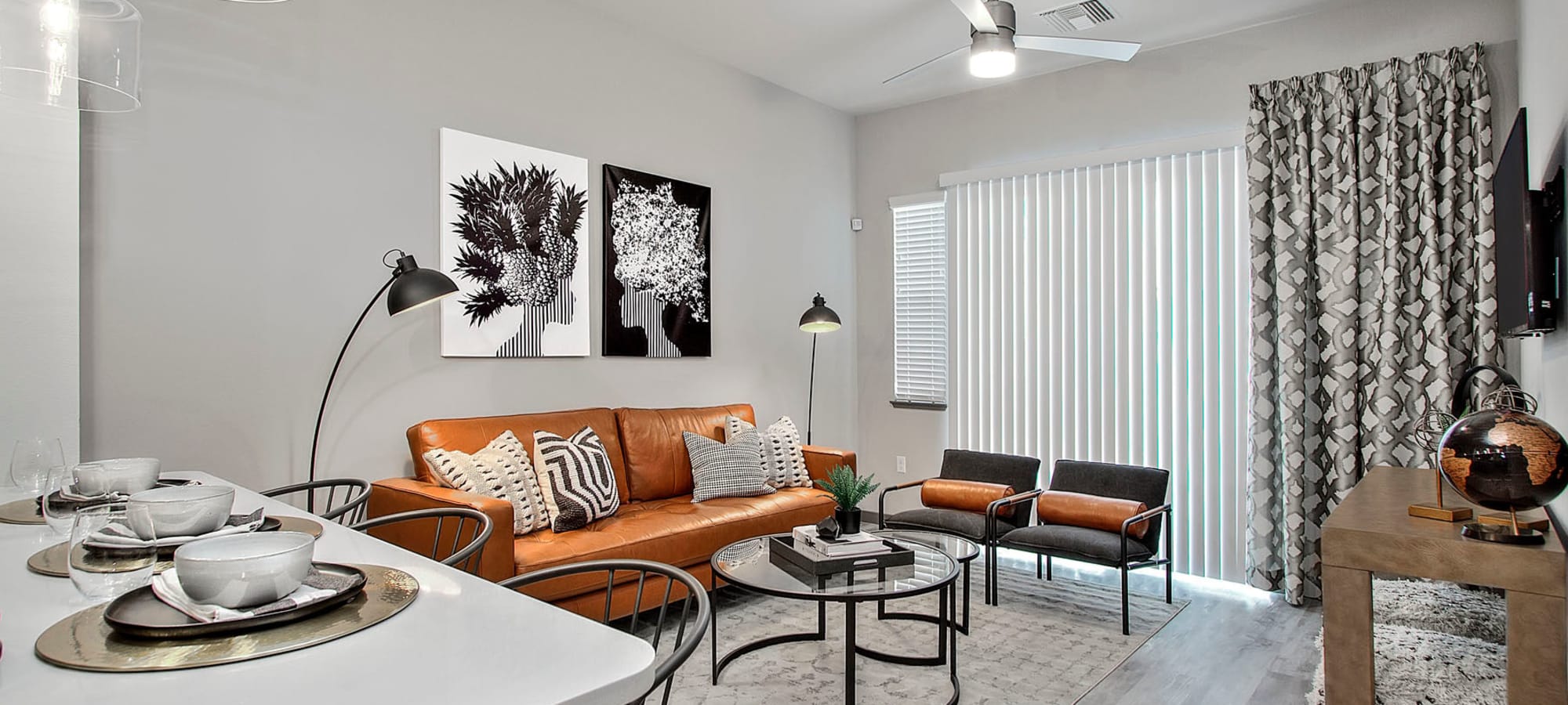 Ceiling fan and vertical blinds in the living space of a model home at Jade Apartments in Las Vegas, Nevada