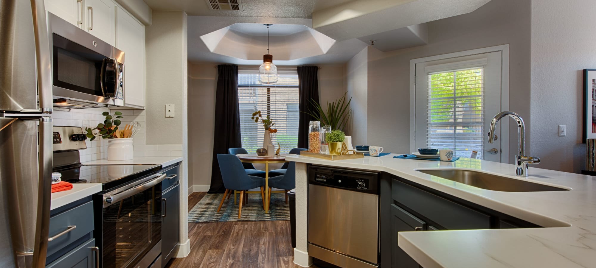 Kitchen with wood flooring and granite countertops at The Ventura in Chandler, Arizona