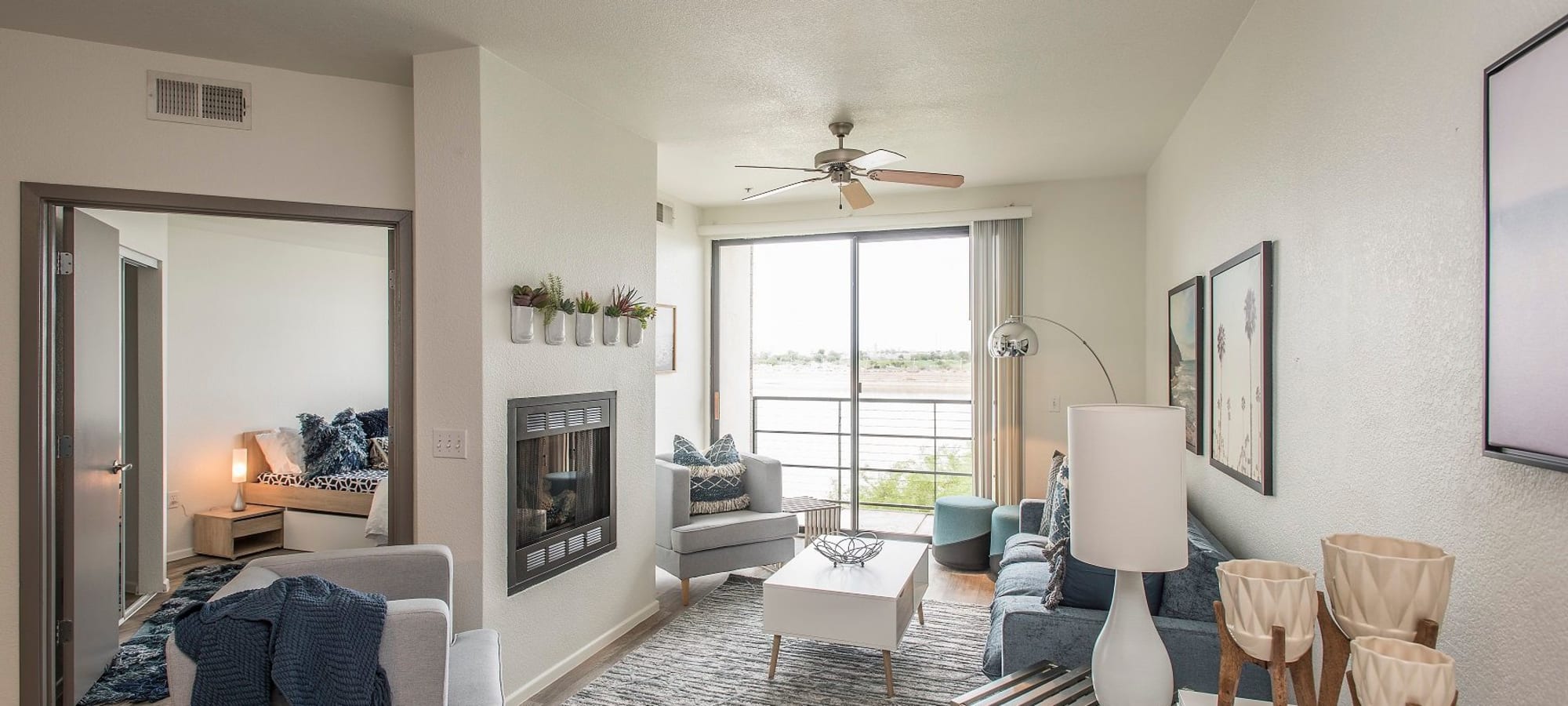 Bedroom, living room, and balcony overlooking Tempe Town Lake at Ten01 on the Lake in Tempe, Arizona