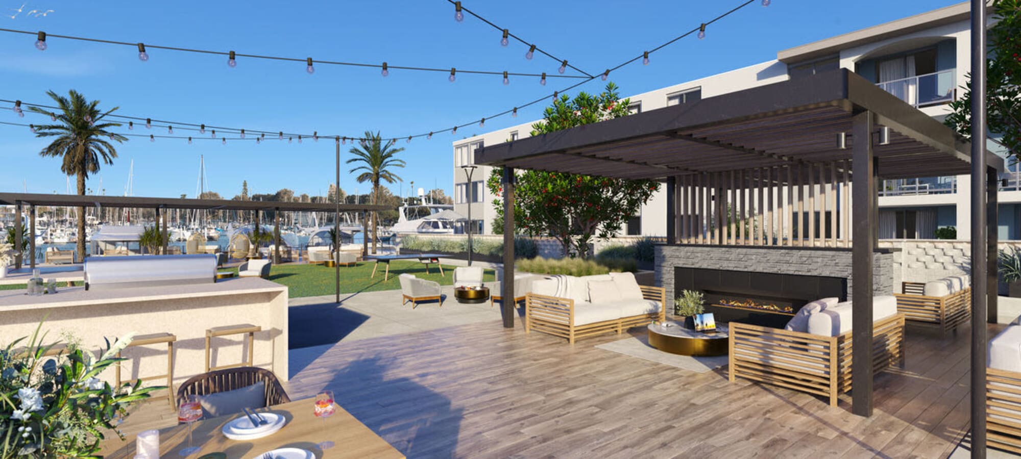 An outdoor fireside lounge and grilling station at Dolphin Marina Apartments in Marina Del Rey, California