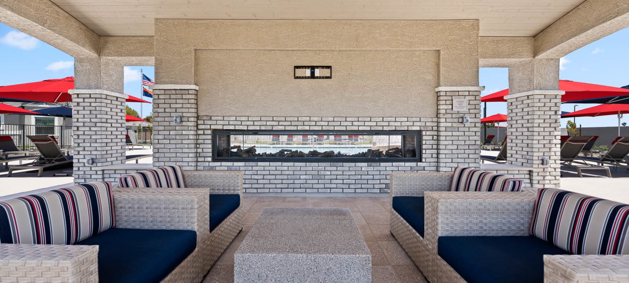 Outdoor seating area with fireplace at Cottages at McDowell in Avondale, Arizona