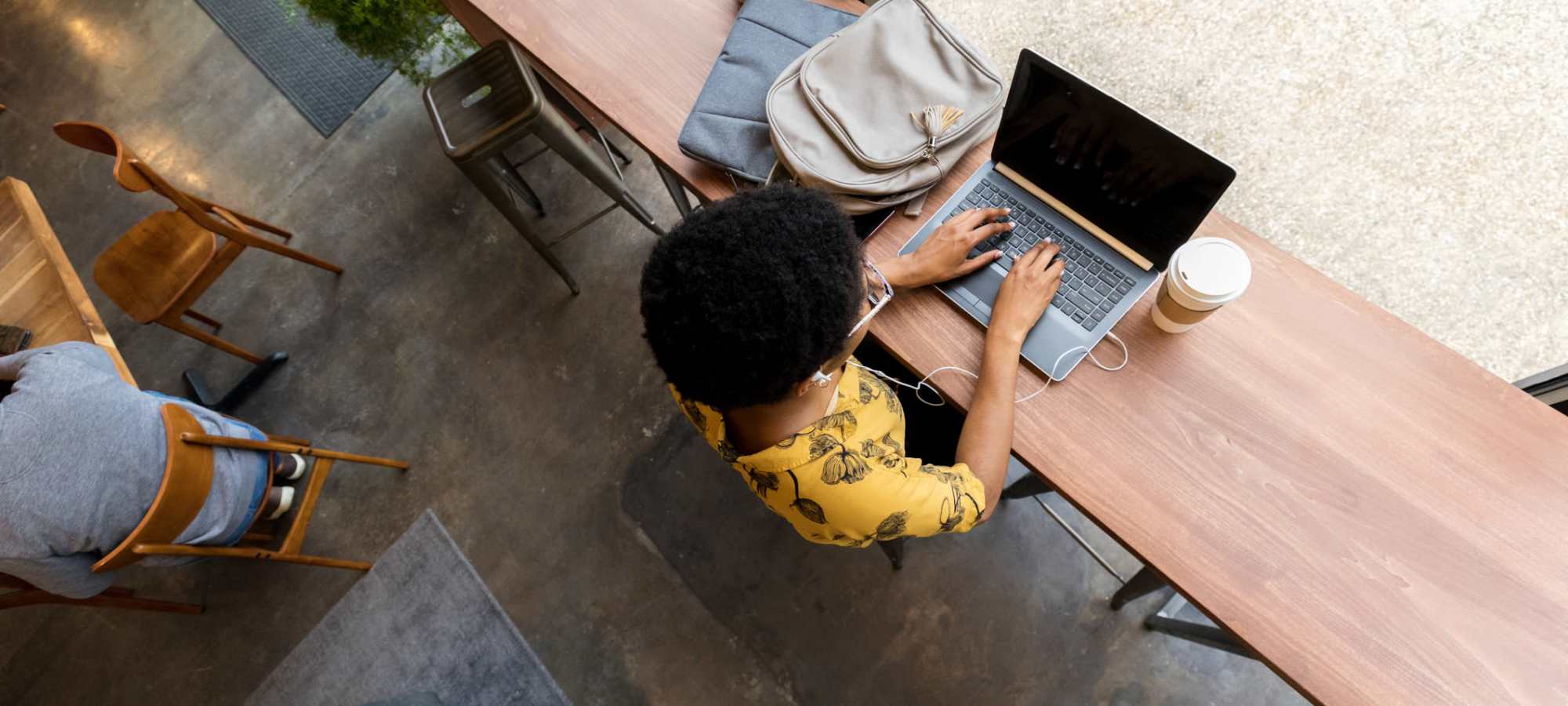 Resident studying at a cafe near The Quarters Manhattan in Manhattan, Kansas