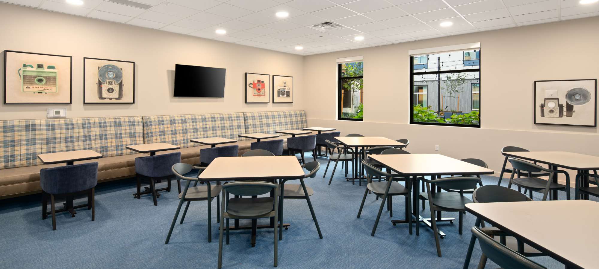 Photo of community multipurpose room with seating and TV at Traditions at Hazelwood in Portland, Oregon