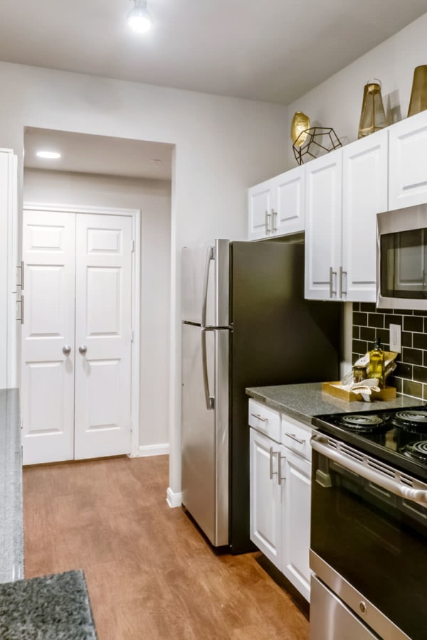 Modern kitchen with stainless-steel appliances in a model apartment at Sonterra Heights in San Antonio, Texas