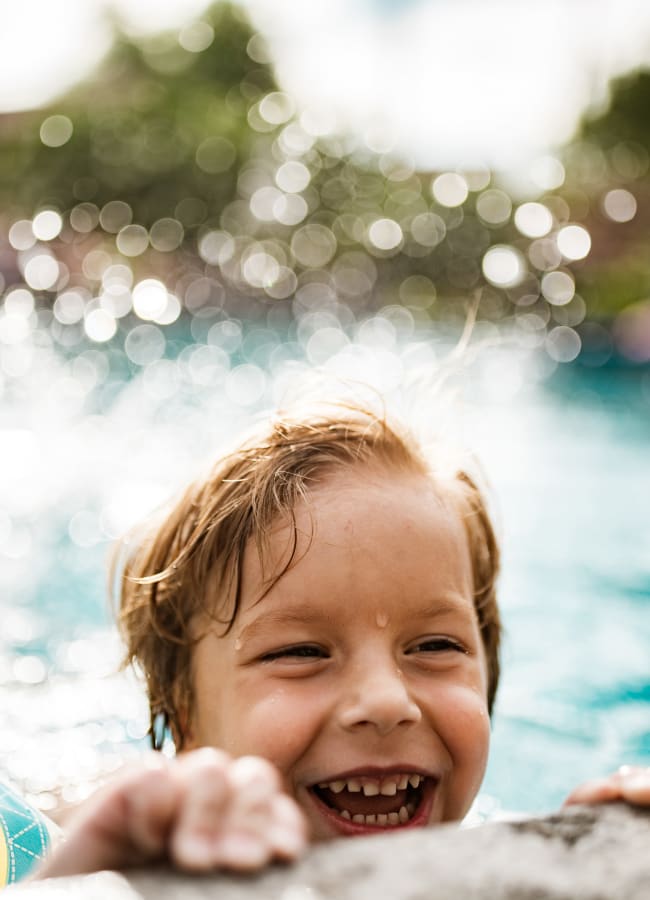 Child having a blast at the community pool at Pentagon Apartment Homes in Fremont, California