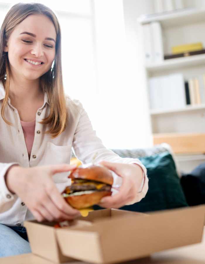 A Student girl eating a hamburger at The Lex in Lexington, Kentucky