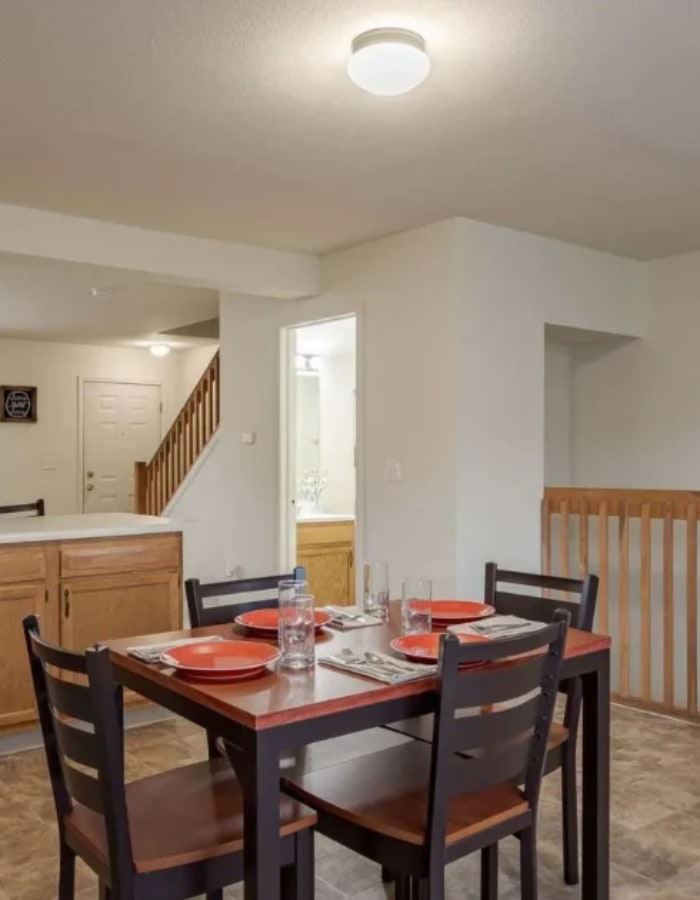 Kitchen with dishwasher and dining area at Copper Beech Town Homes in Clovis, California