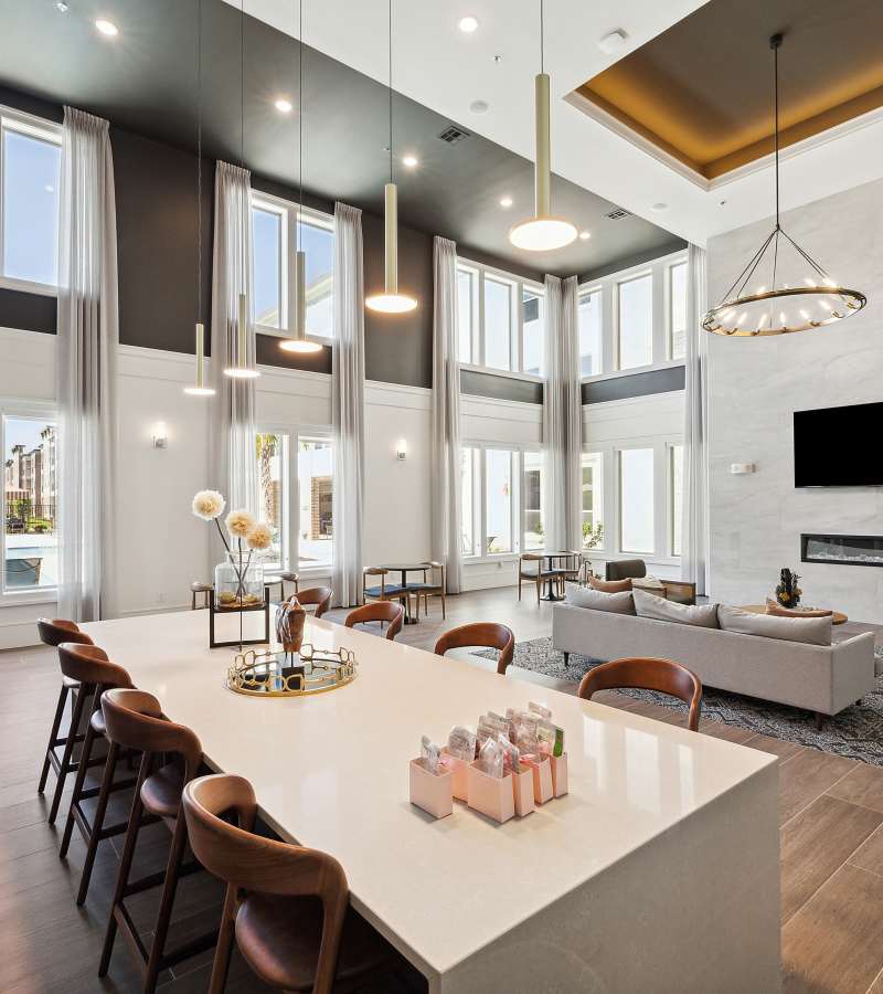 Long white countertop with brown stools at Dakota at Deer Park in Deer Park, Texas