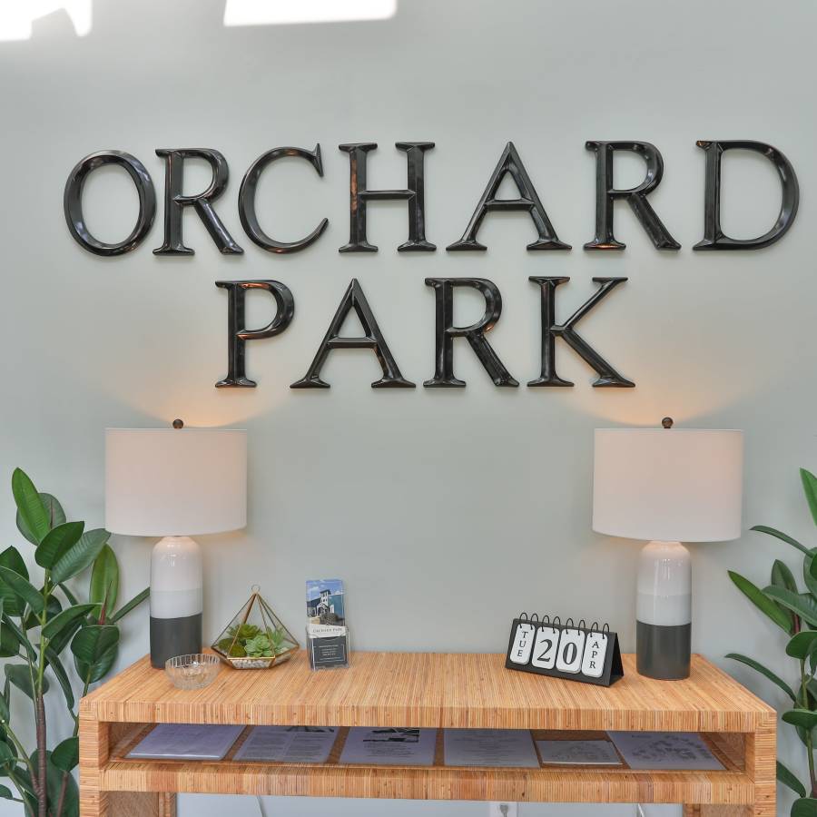 signage in the community center at Acasă Orchard Park Apartments in Greenville, South Carolina
