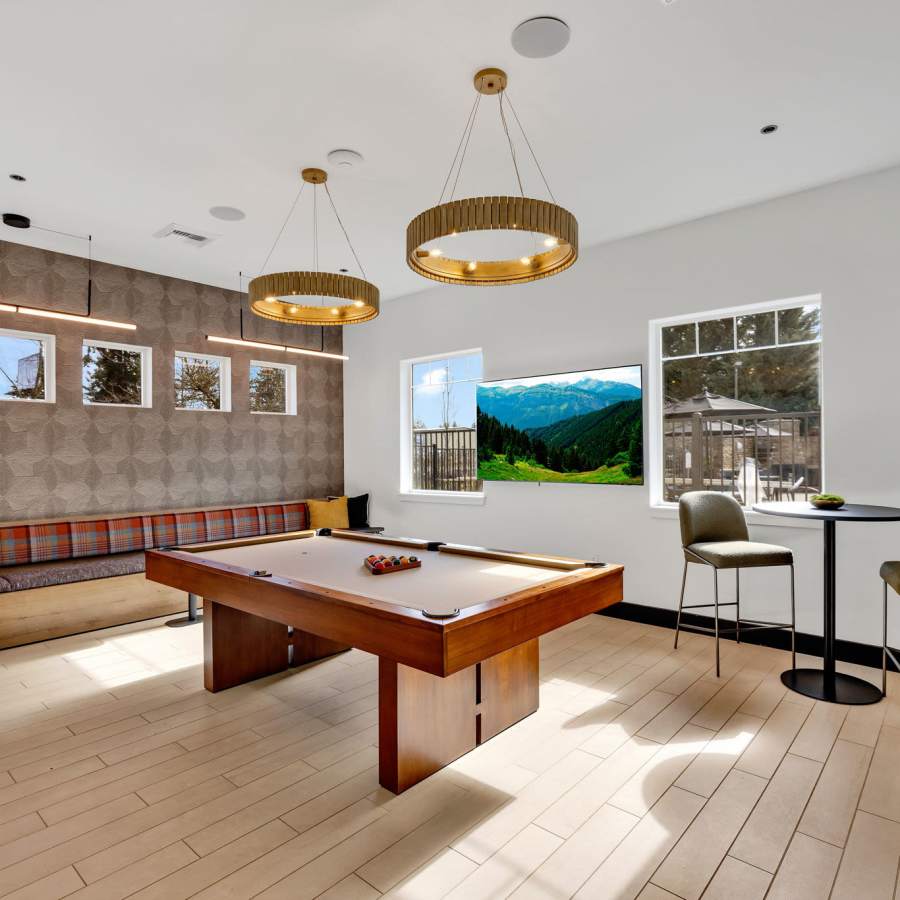 Spacious community lounge with a fireplace and comfortable seating at The Meadows in Tacoma, Washington