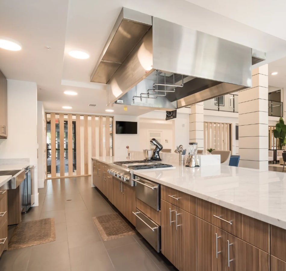 A modern kitchen with lots of counterspace in the community lounge at The Vivien in Vero Beach, Florida