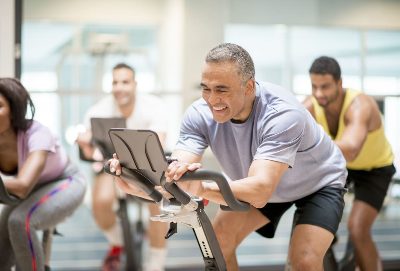 Residents biking at our on-site gym at Bolton House
