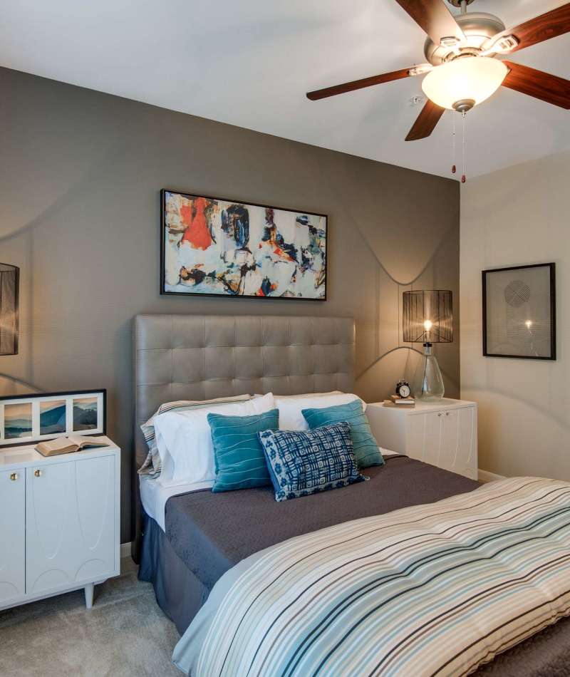 Cozy bedroom with ceiling fan at Legacy at Meridian in Durham, North Carolina
