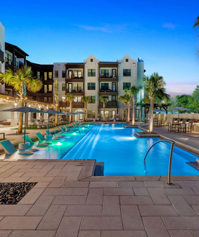 Beautiful view of the apartments exterior by the pool at Palmilla | Luxury Apartments & Townhomes in Pensacola, Florida