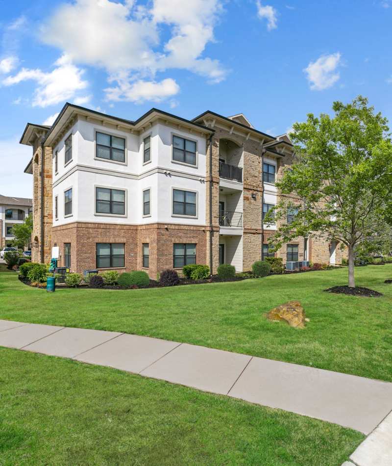 Exterior building view with large windows at Sorrel Phillips Creek Ranch in Frisco, Texas