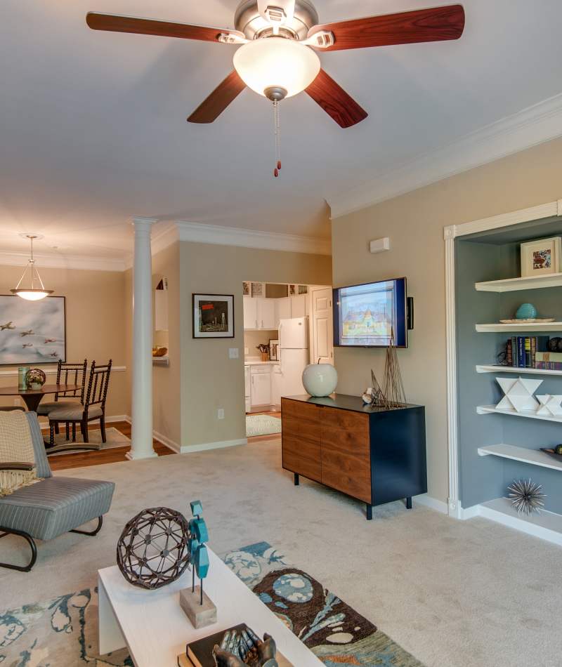 Living room with ceiling fan at Legacy at Meridian in Durham, North Carolina