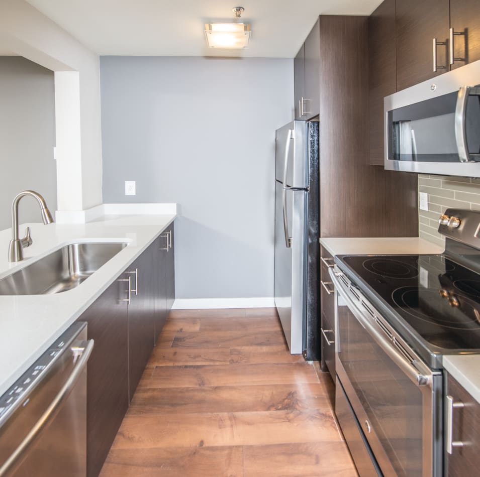 Kitchen with hardwood flooring in a model home at 2900 on First Apartments in Seattle, Washington