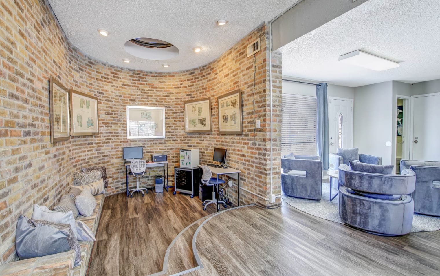 Upscale San Antonio Apartments in the medical district, complete with a stylish living room featuring a fireplace and charming brick walls.