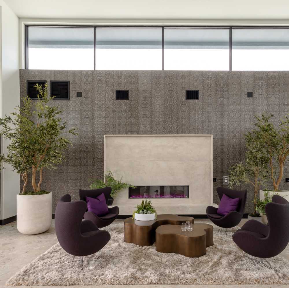 Seating arrangement with plants and fireplace at Continuum Apartments in Las Vegas, Nevada