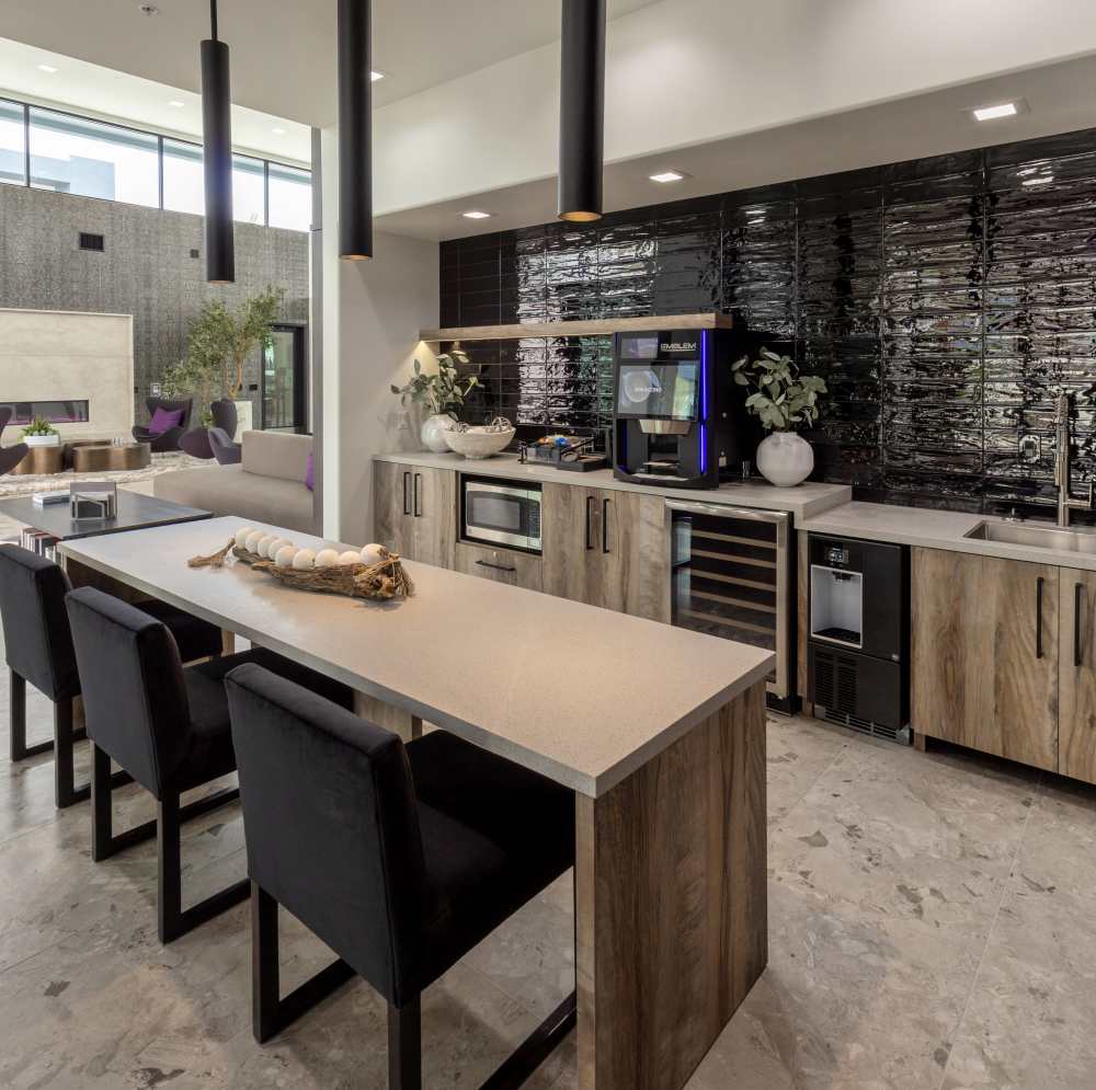 Kitchen area with dark backsplash and bar seating at Continuum Apartments in Las Vegas, Nevada