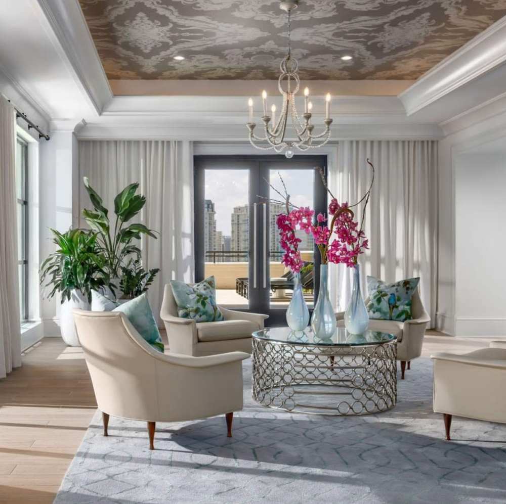 Bright living room with elegant chandelier at Novel Turtle Creek in Dallas, Texas