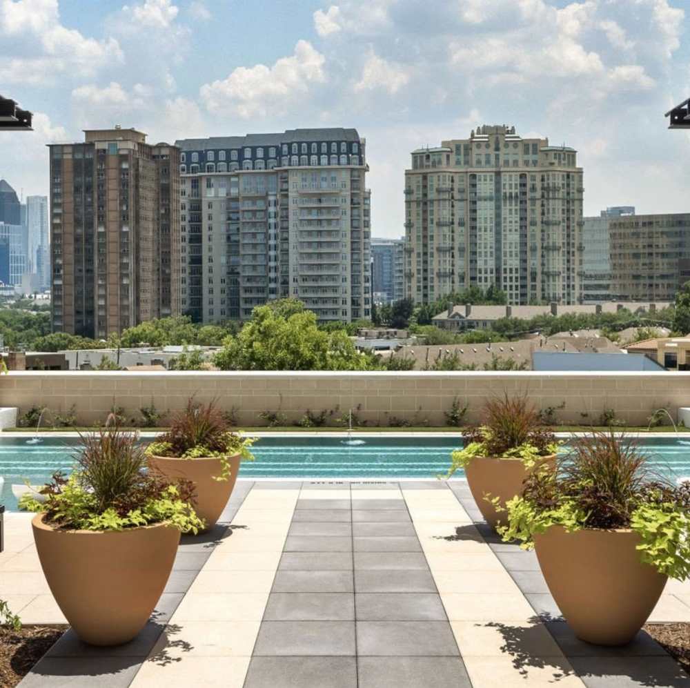 Resort-style pool with landscaped planters at Novel Turtle Creek in Dallas, Texas