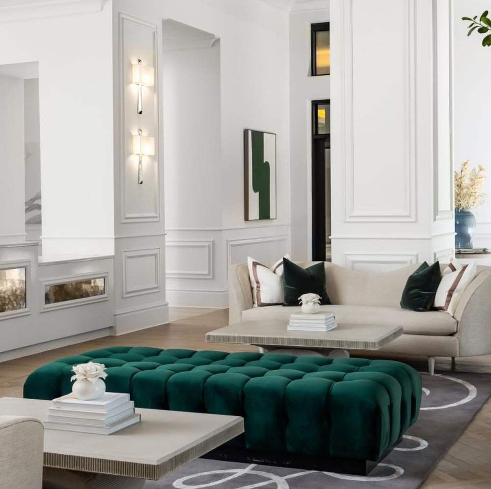 Modern lounge area with plush green ottoman at Novel Turtle Creek in Dallas, Texas