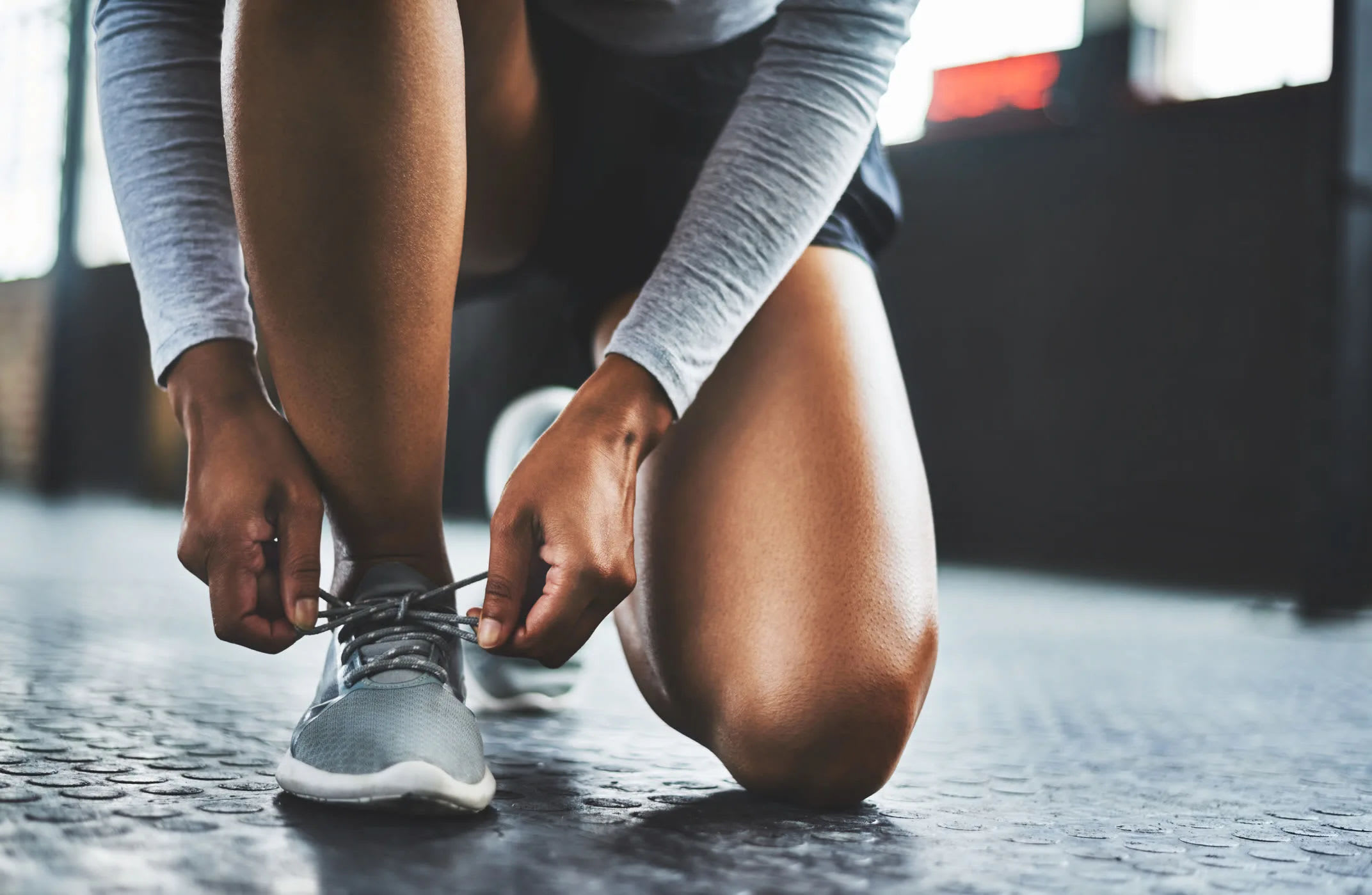 Resident tying their shoes and getting ready to use the on-site fitness facility at Reserves at Tidewater in Norfolk, Virginia