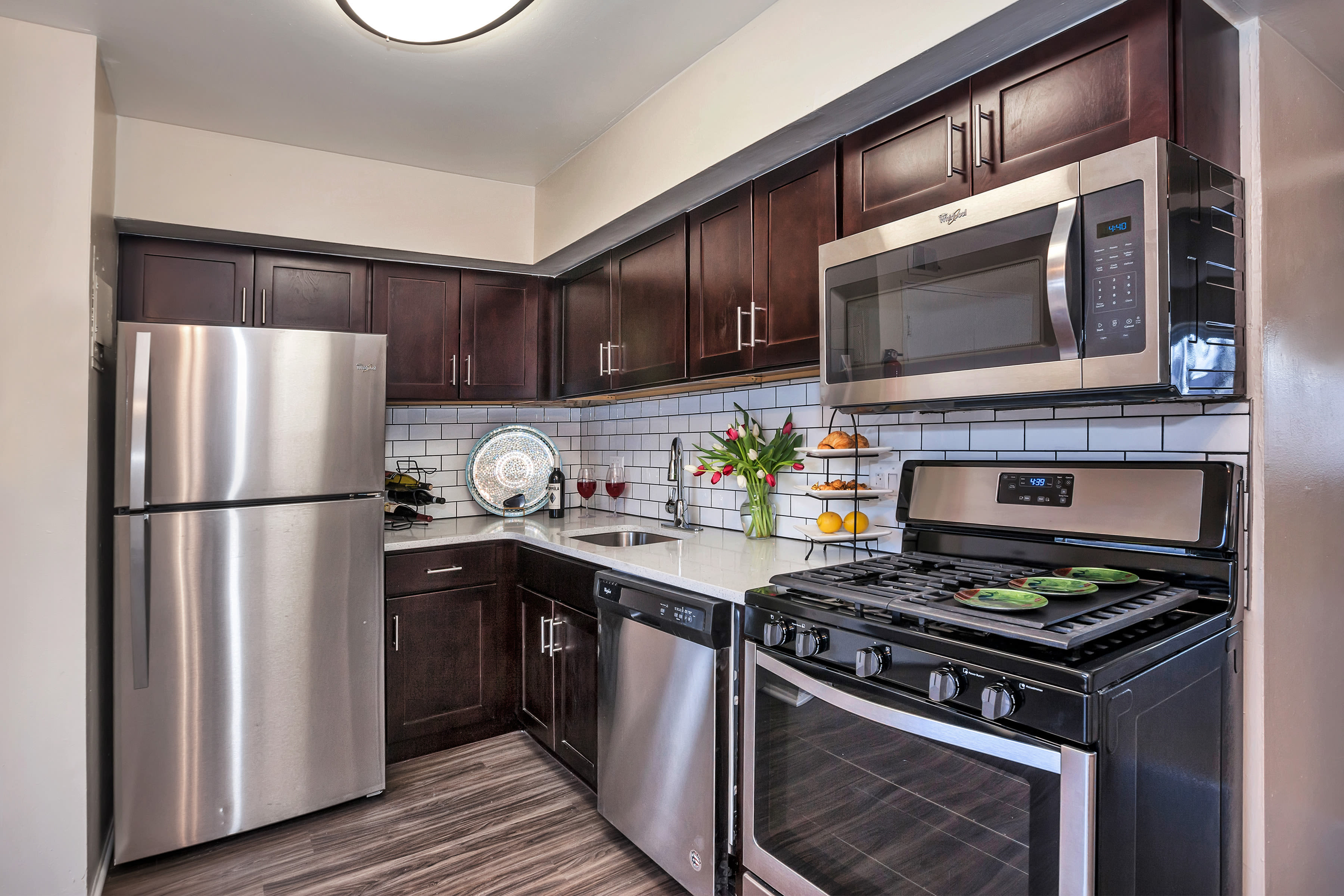 Kitchen with white appliances, cabinets and countertops at Franklin Commons, Bensalem, Pennsylvania