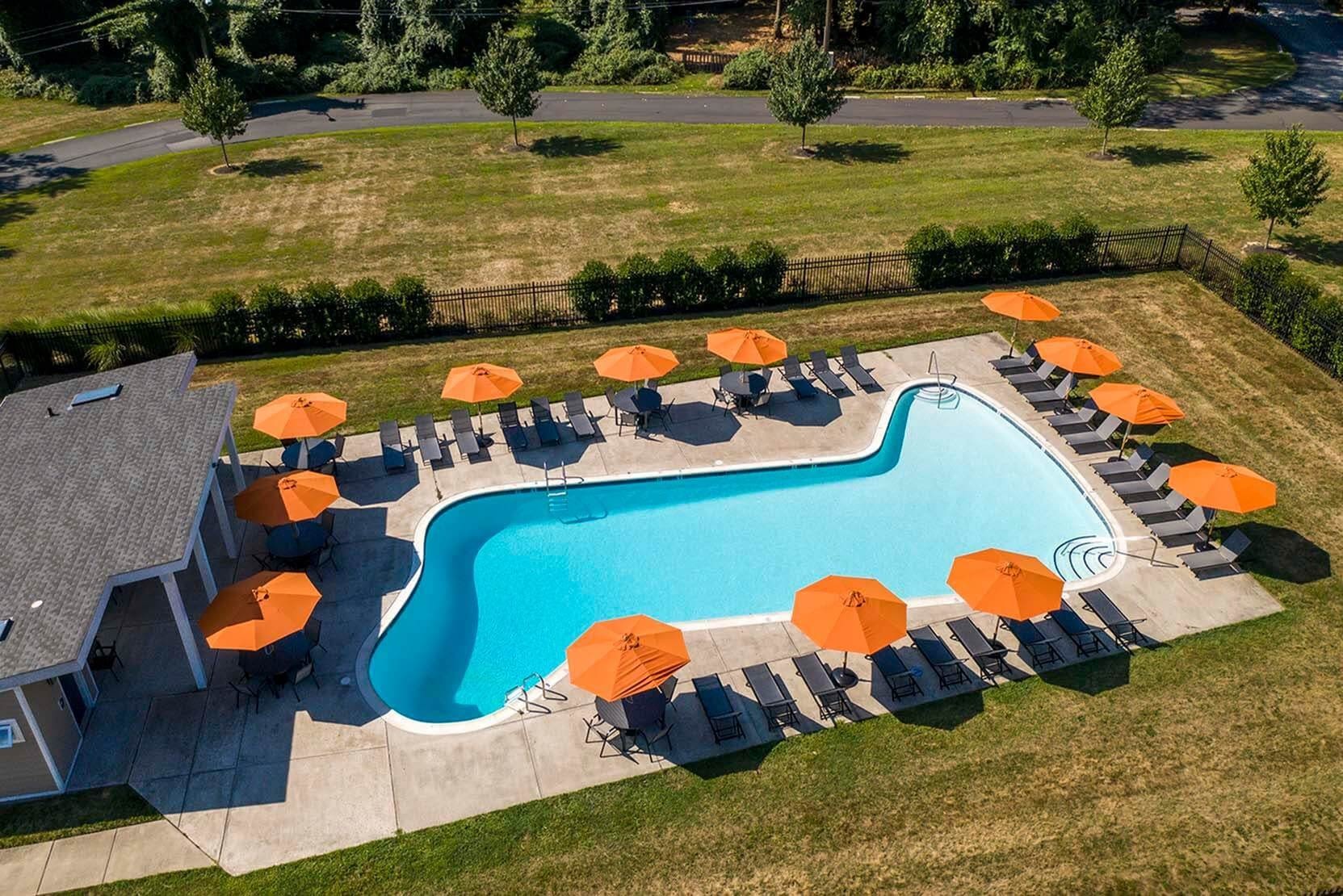Sparkling pool with lounge chairs and umbrella at The Wellington, Hatboro, Pennsylvania