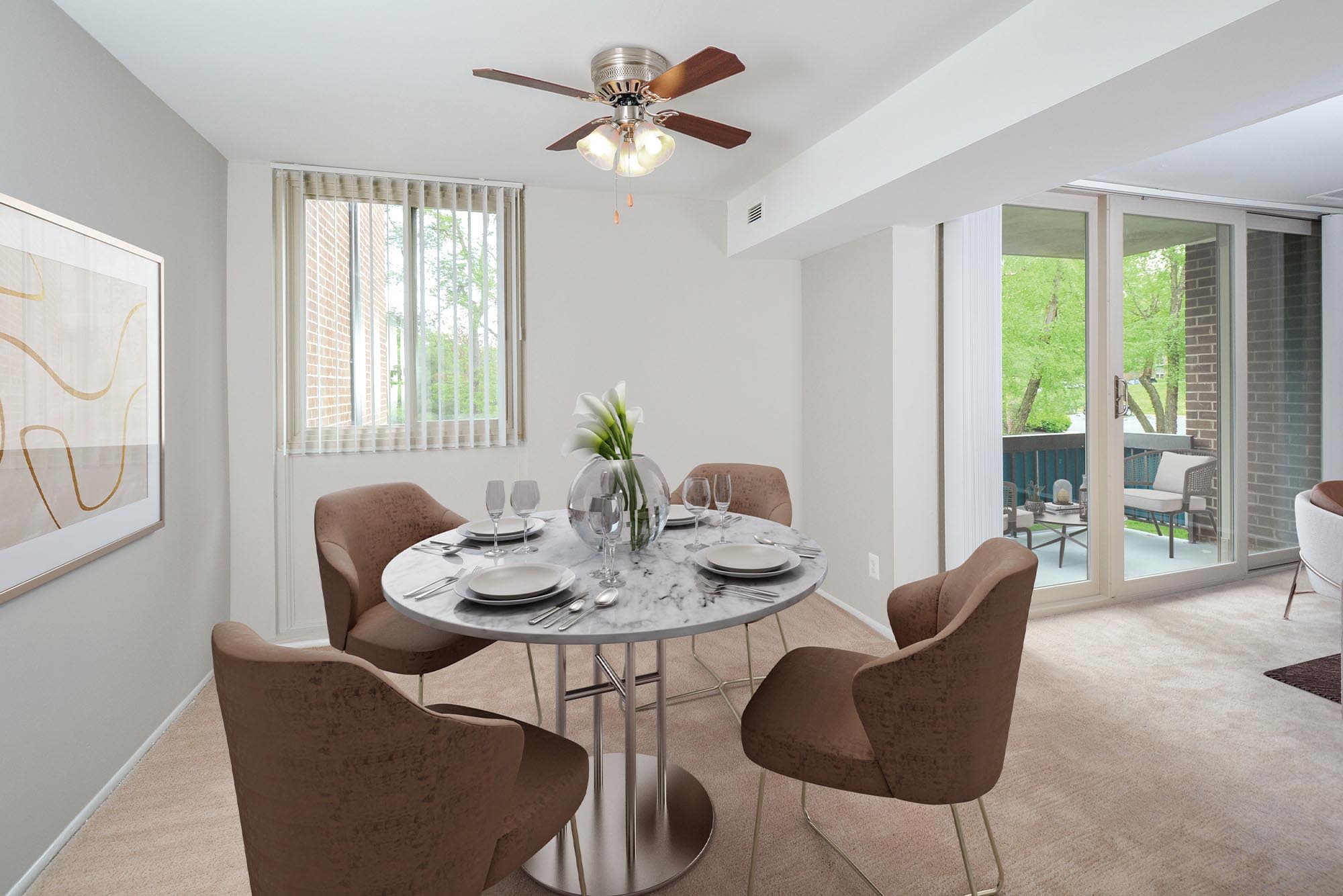 Dining area with a ceiling fan in a model apartment home at Landmark Glenmont Station in Silver Spring, Maryland