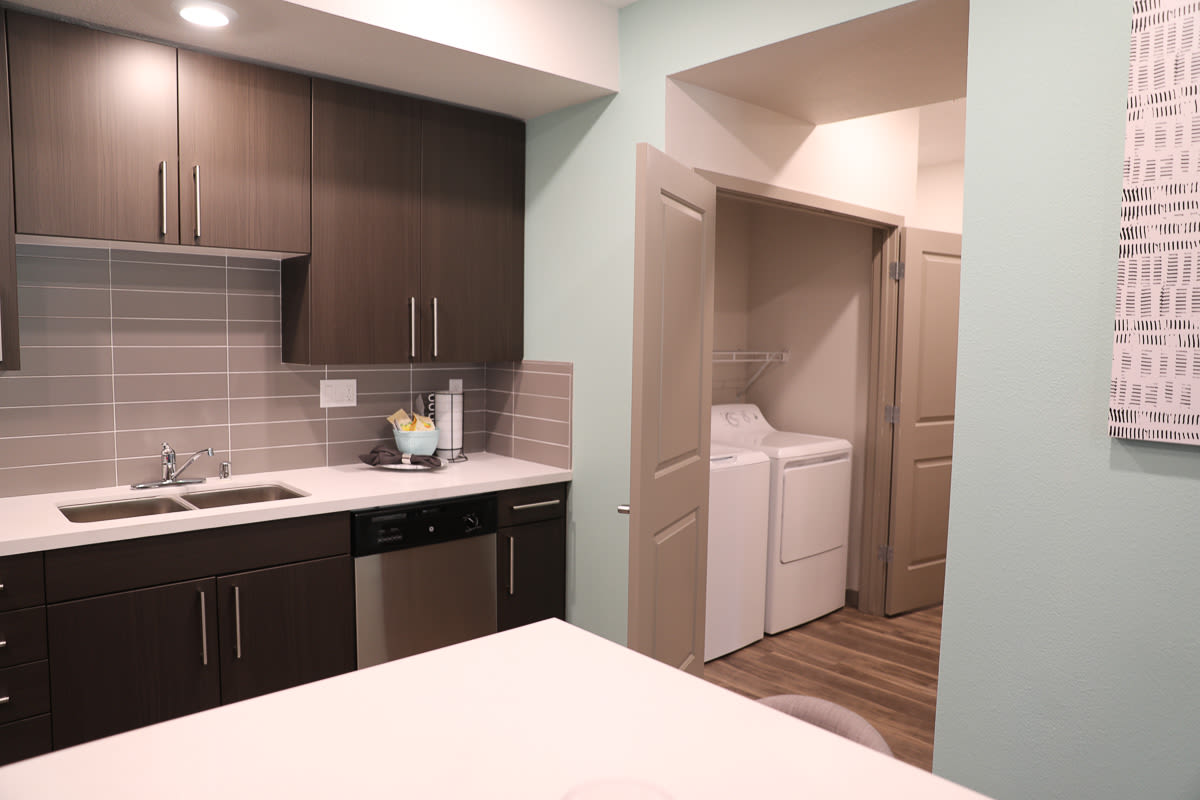 Kitchen with white appliances, cabinets and countertops at Sutter Green Apartments, Sacramento, California