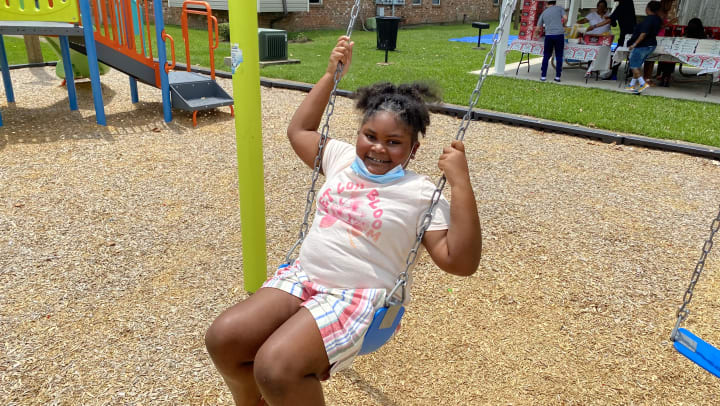 Girl plays on new Playground at Summerfield Apartment Homes