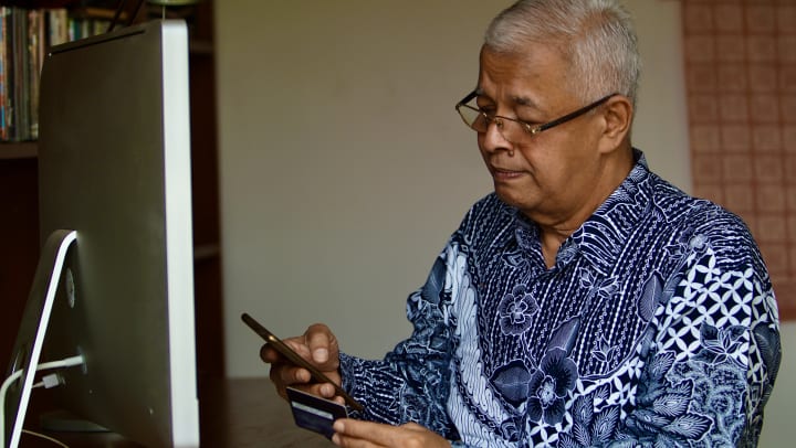 Senior man making payment online
