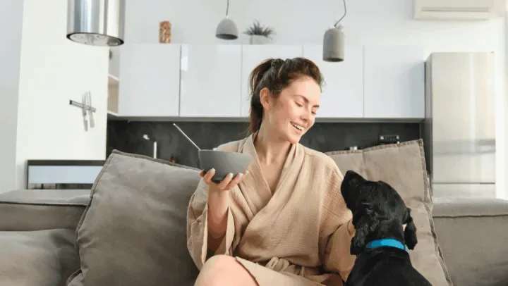 Resident with her pet in a living room